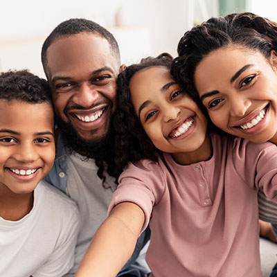 A smiling family taking a selfie together.